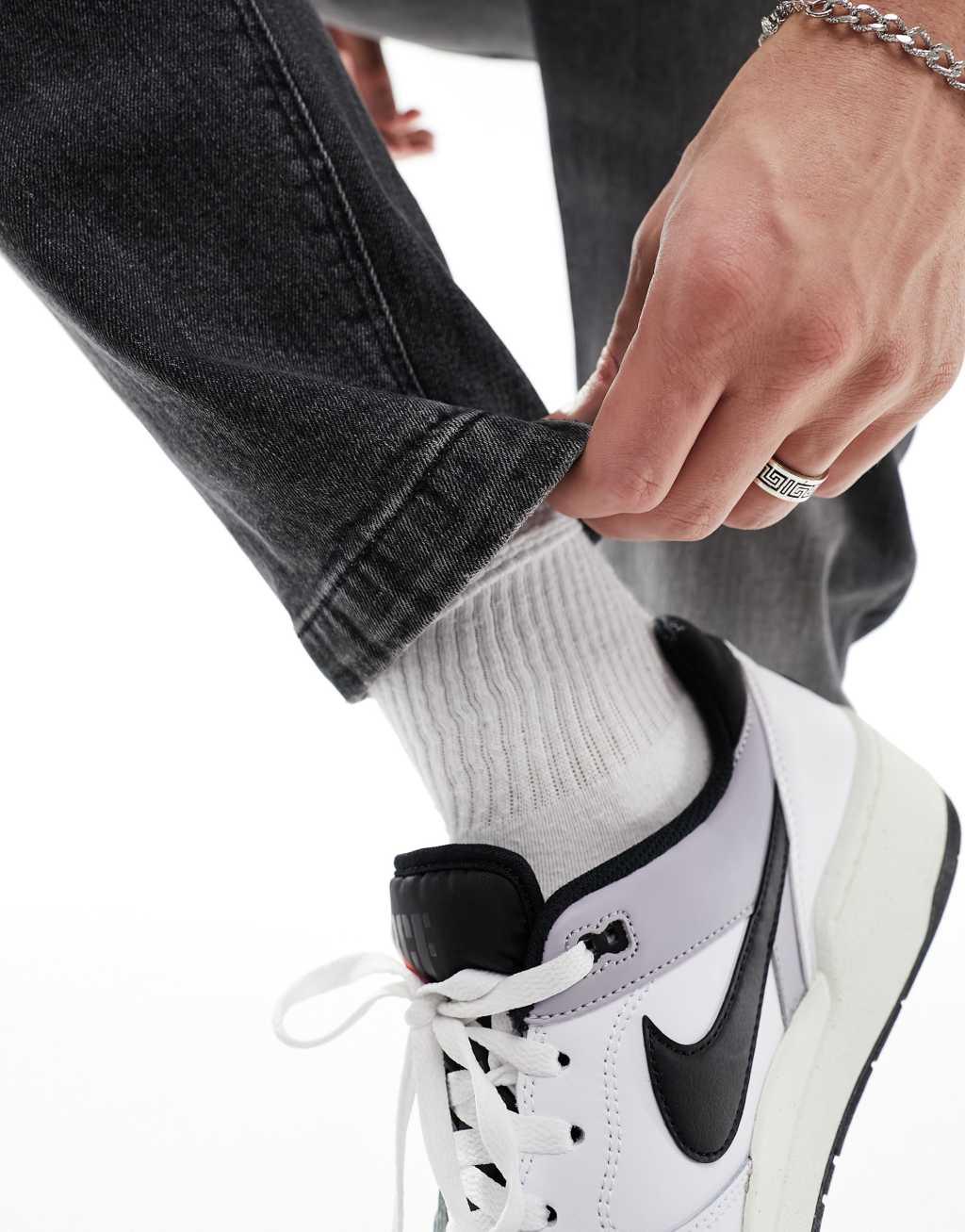 ASOS DESIGN stretch tapered jeans in washed black Product Image