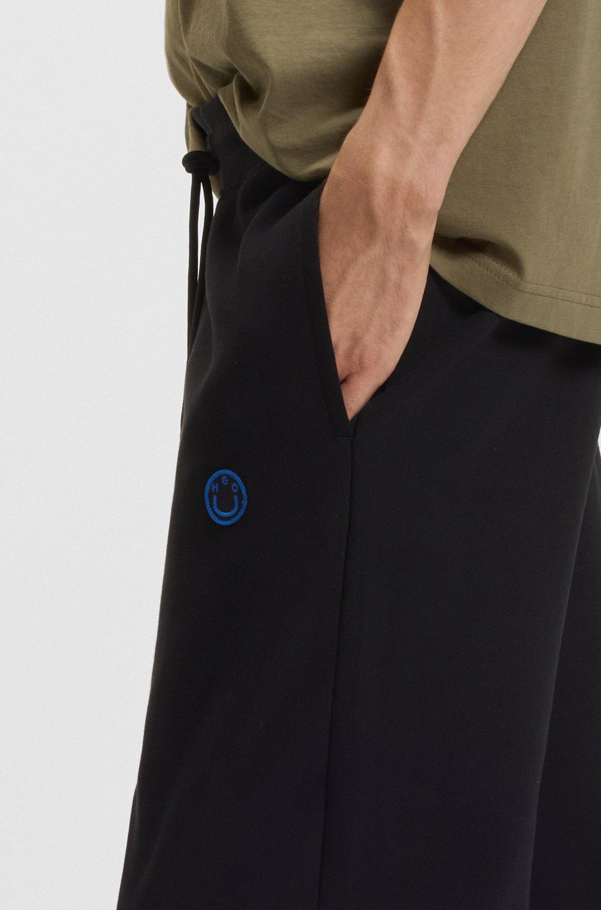 Cotton-terry tracksuit bottoms with Happy HUGO Product Image