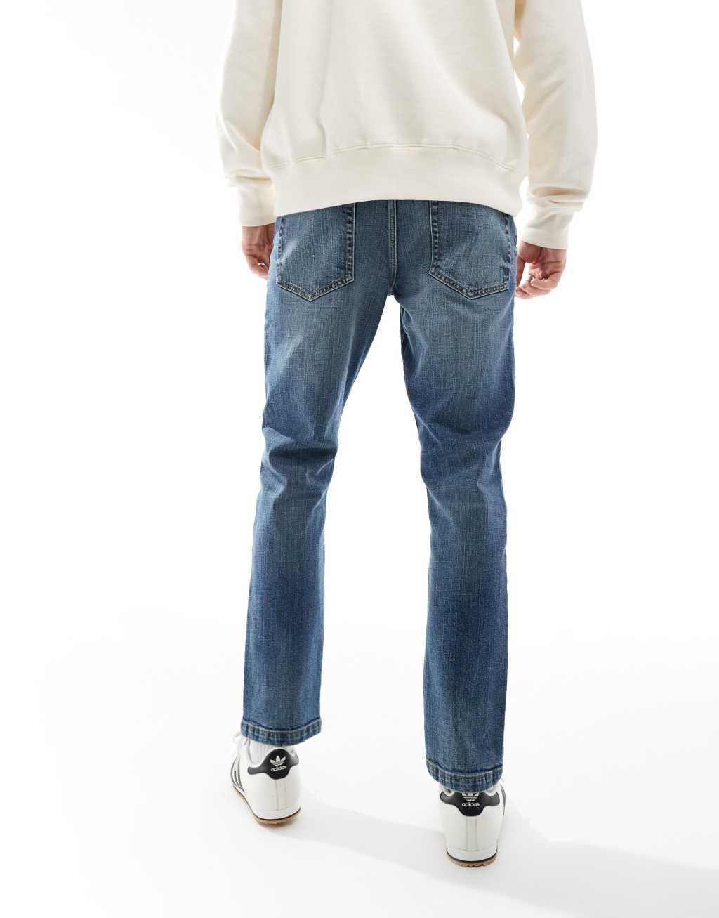 ASOS DESIGN slim jeans in mid wash blue with tint Product Image