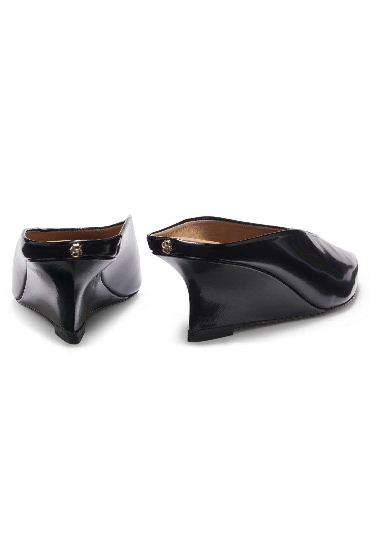 Wedge-heel mules in leather Product Image