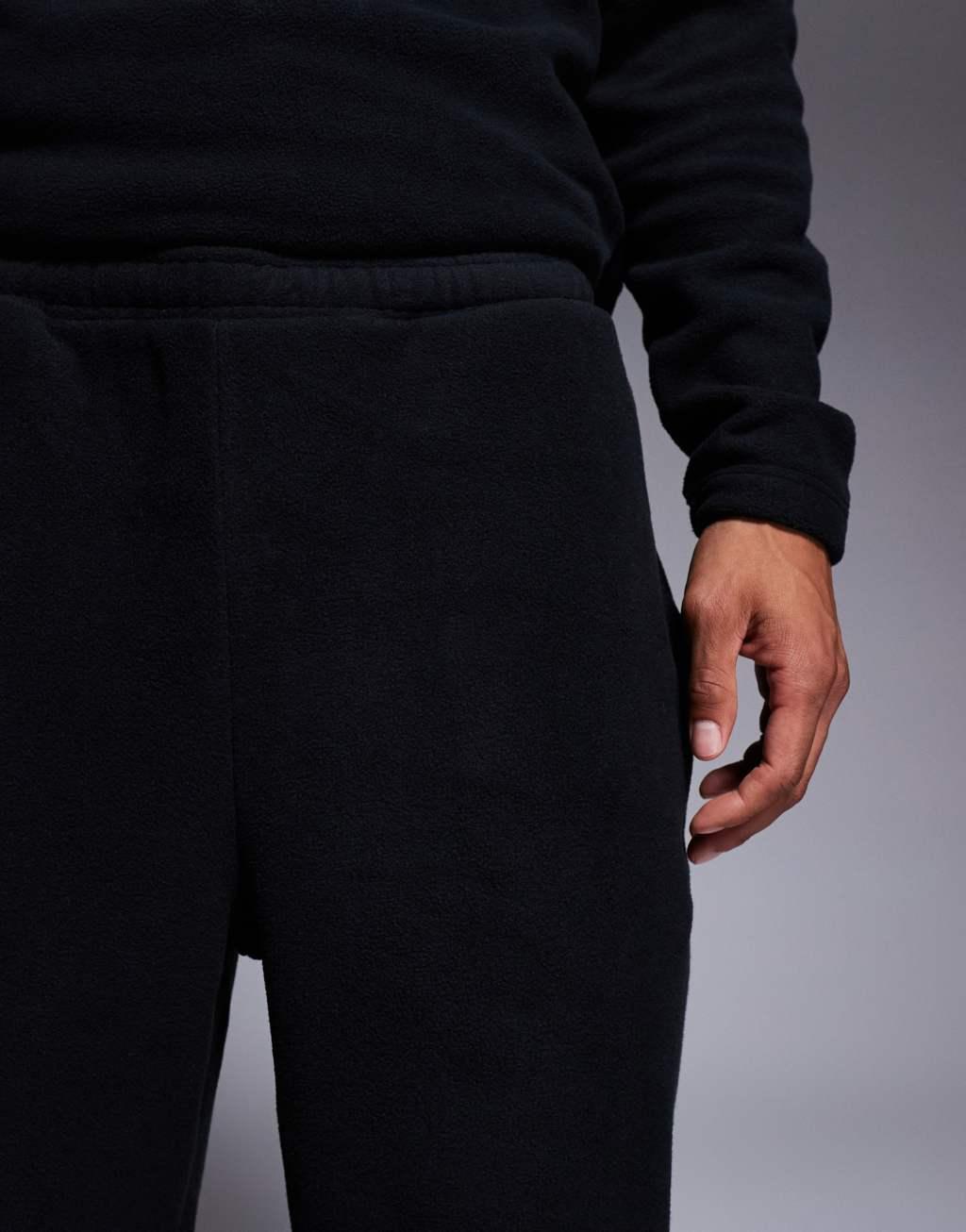 ASOS DESIGN tapered fleece sweatpants in black Product Image