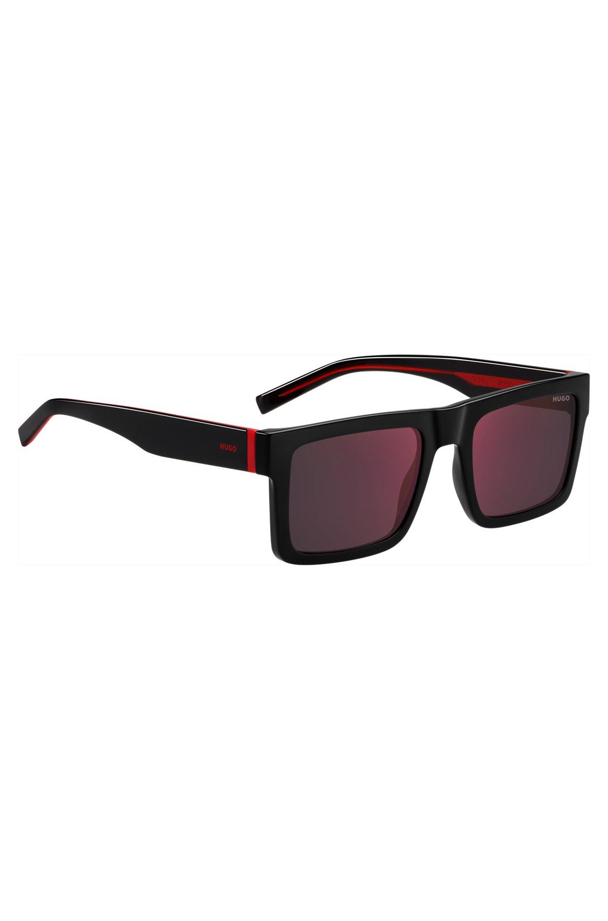 Black sunglasses with signature red accents Product Image
