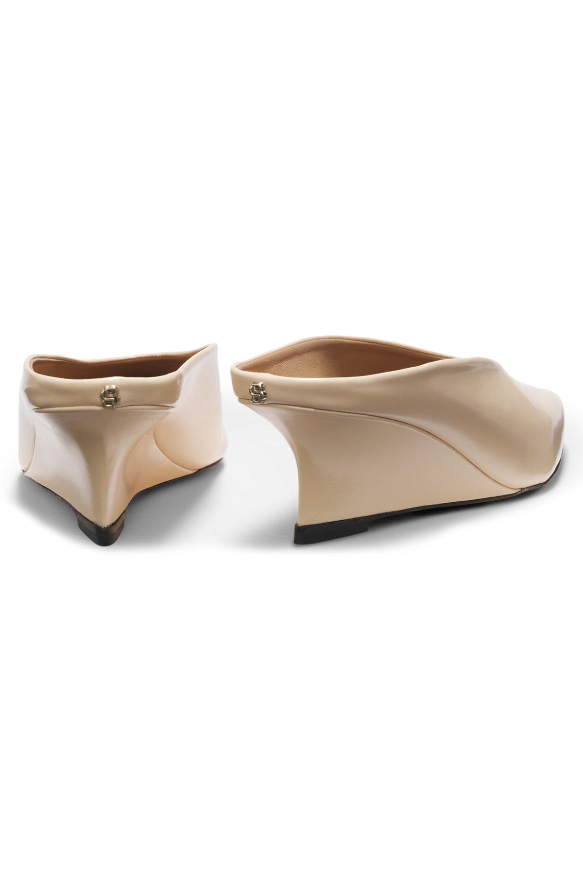 Wedge-heel mules in leather Product Image
