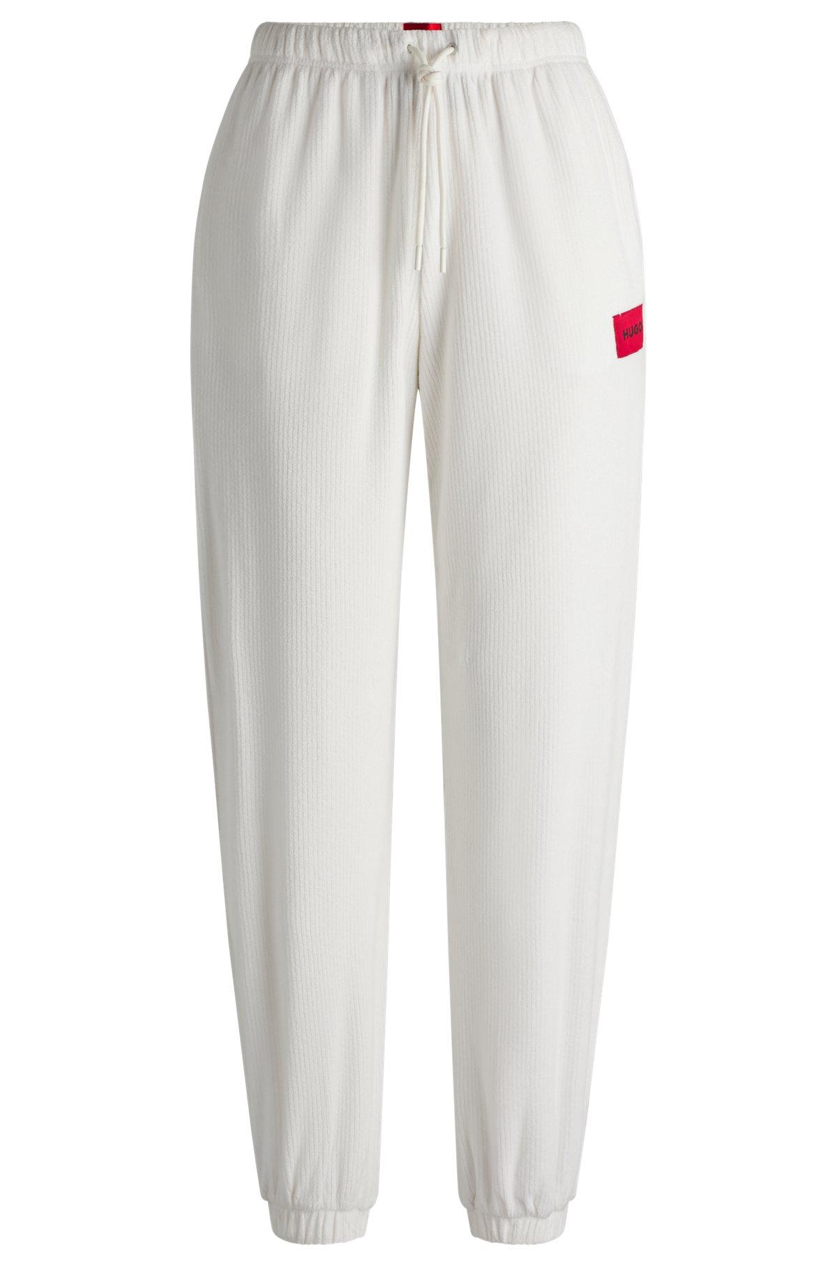 Tracksuit bottoms with red logo label Product Image