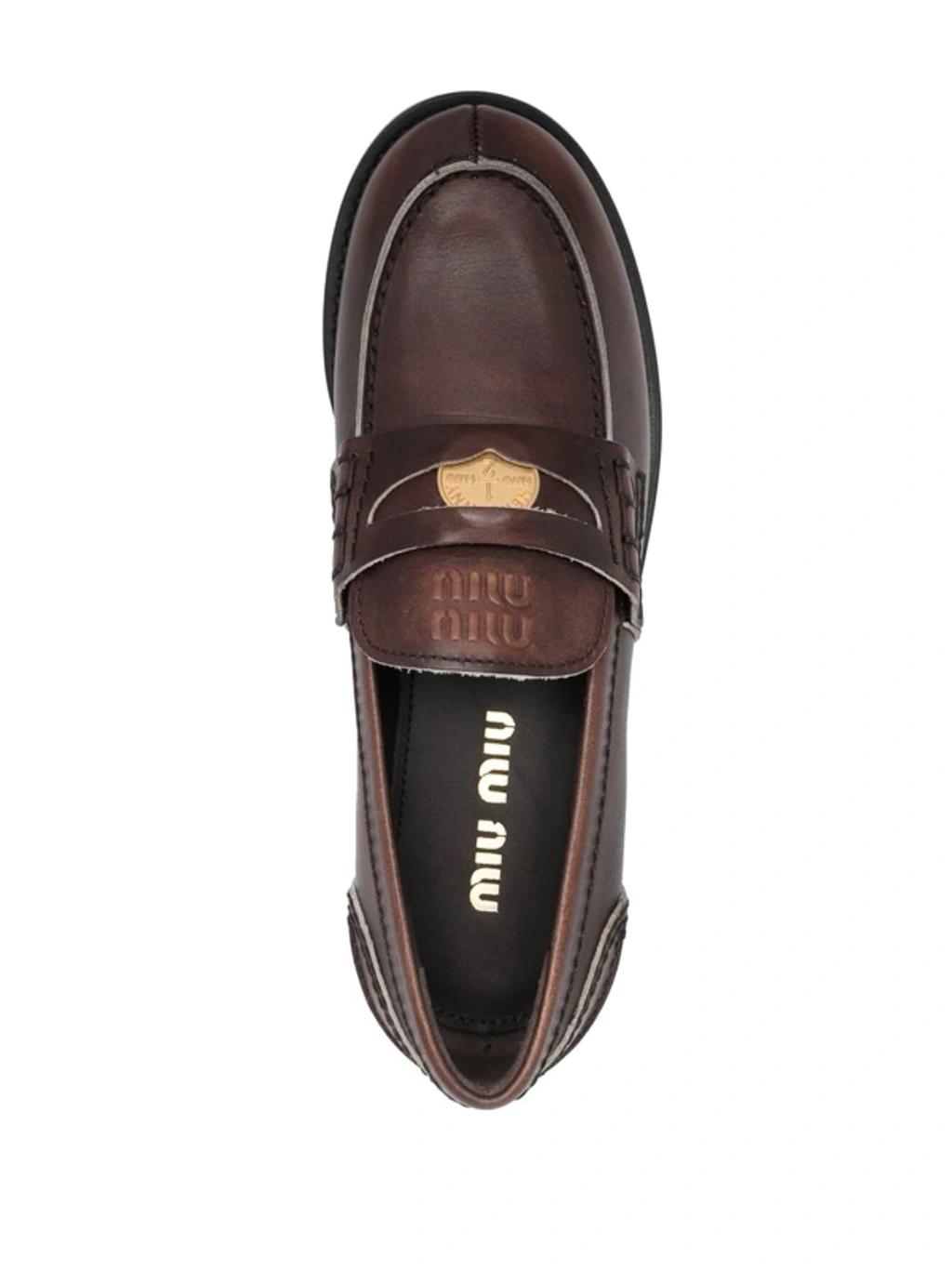 MIU MIU Leather Distressed Penny Loafers In Brown Product Image
