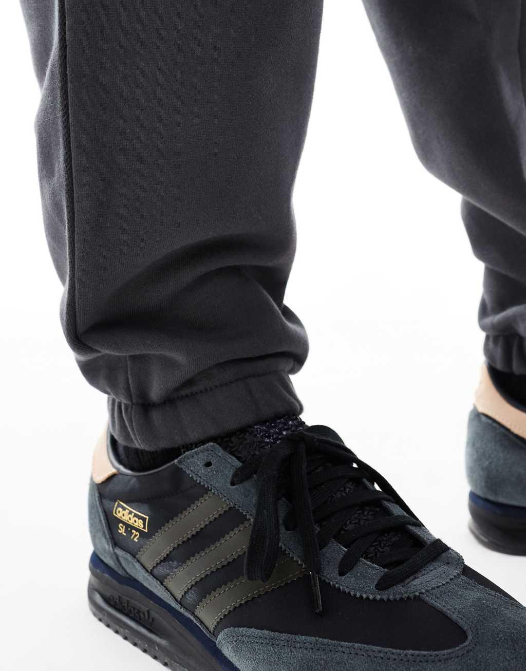 ASOS DESIGN premium heavyweight tapered sweatpants in washed black Product Image