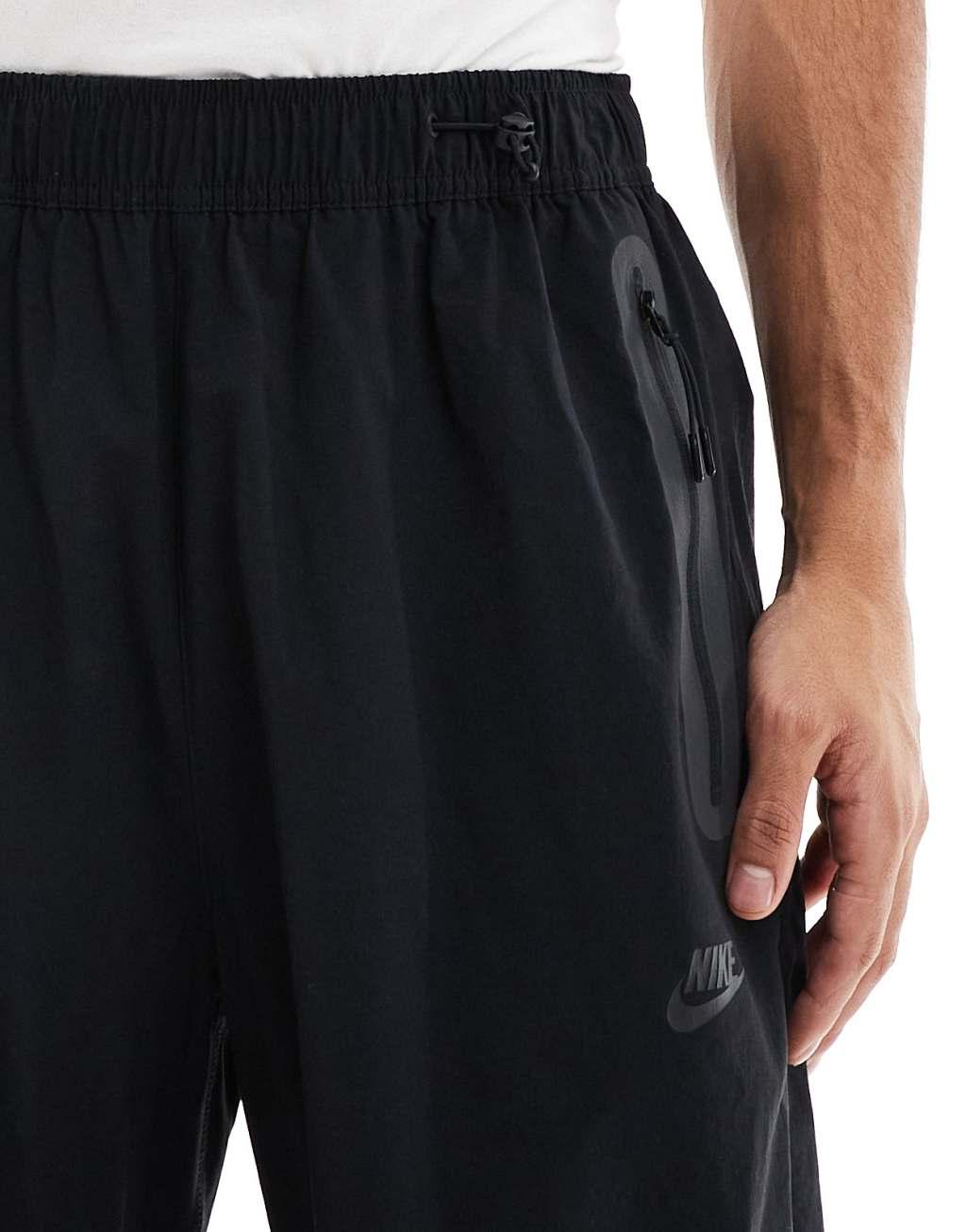 Nike Tech Woven oversized pants in black Product Image