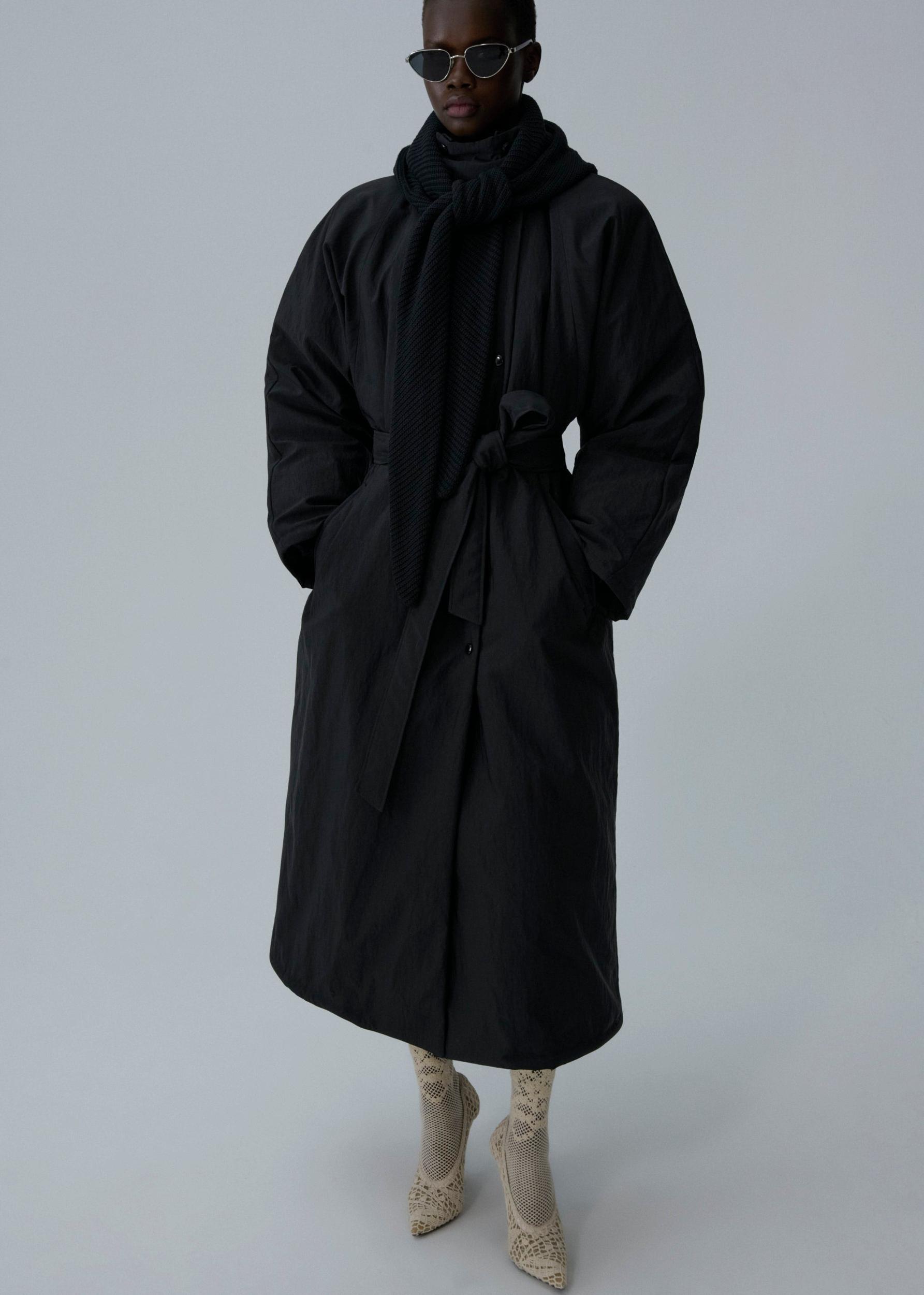 Knit hood long puffer coat in black Product Image