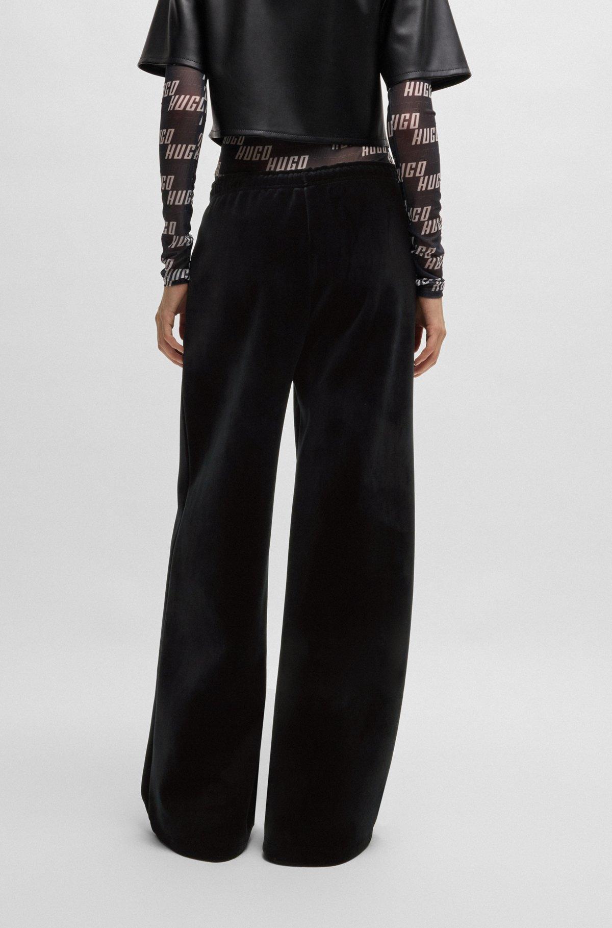Relaxed-fit tracksuit bottoms in stretch velour Product Image
