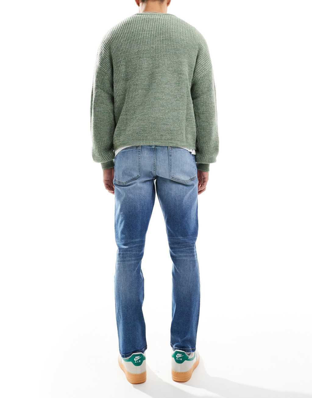 ASOS DESIGN stretch slim jeans in mid wash blue Product Image