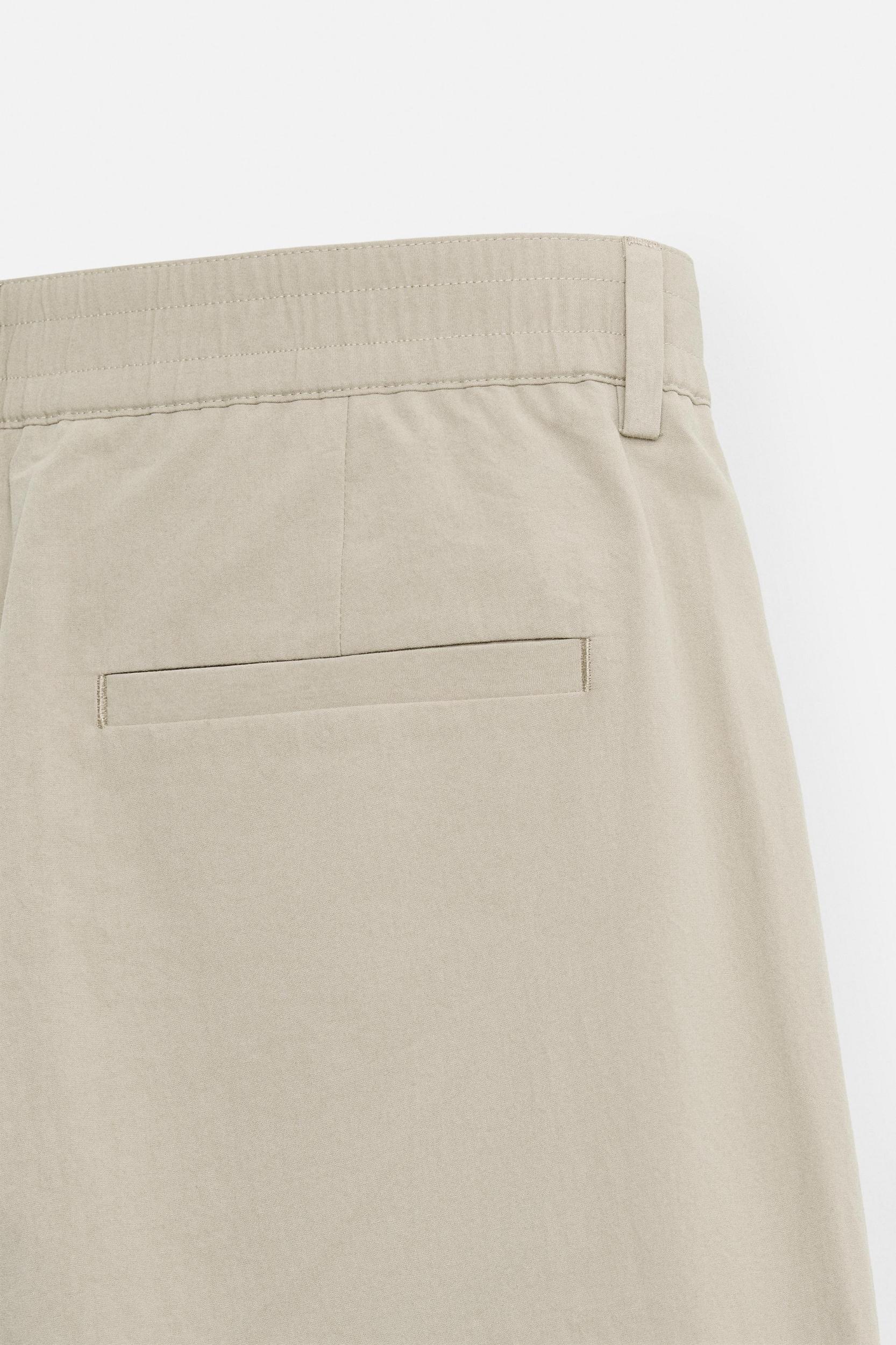 PLEATED CHINO PANTS Product Image