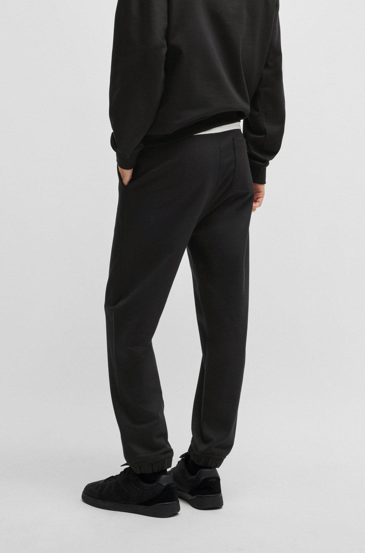 Cotton-terry tracksuit bottoms with smoke logo Product Image
