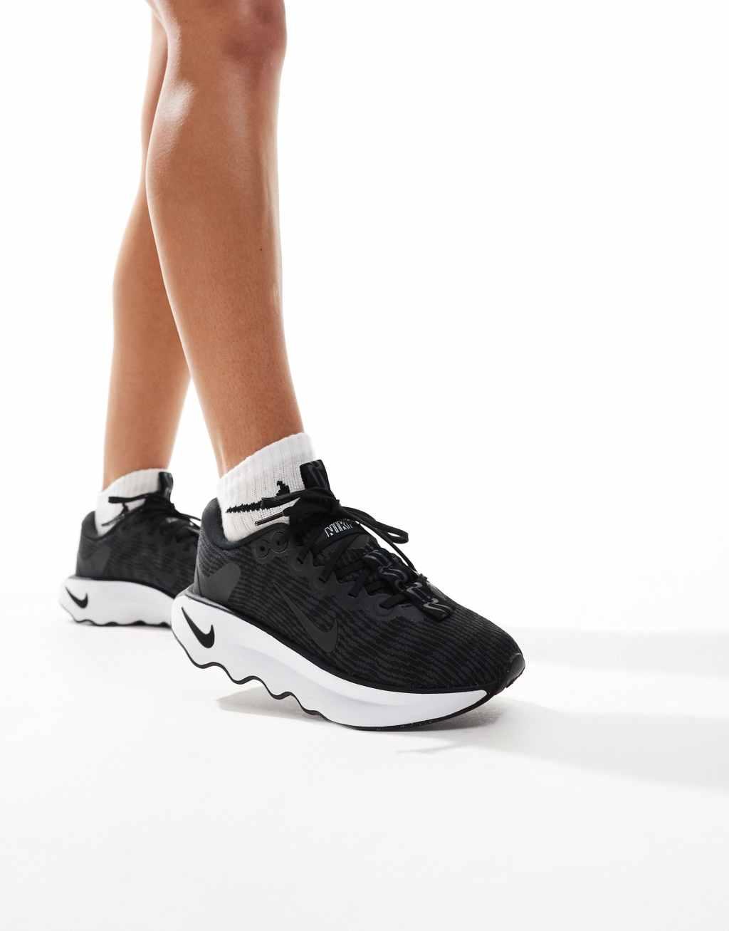 Nike Training Motiva sneakers in black and white Product Image