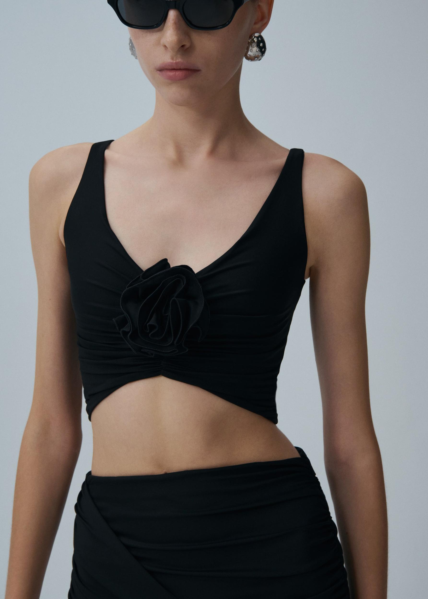 Ruched flower top in black Product Image