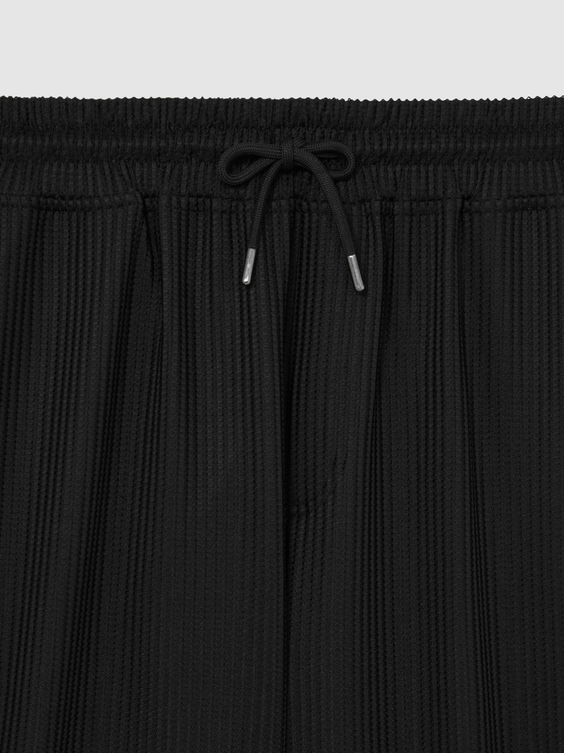 Textured-Knit Tapered Trousers in Black Product Image