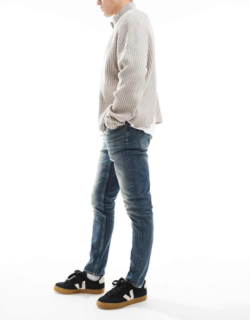 ASOS DESIGN skinny jeans with green tint in light wash blue Product Image