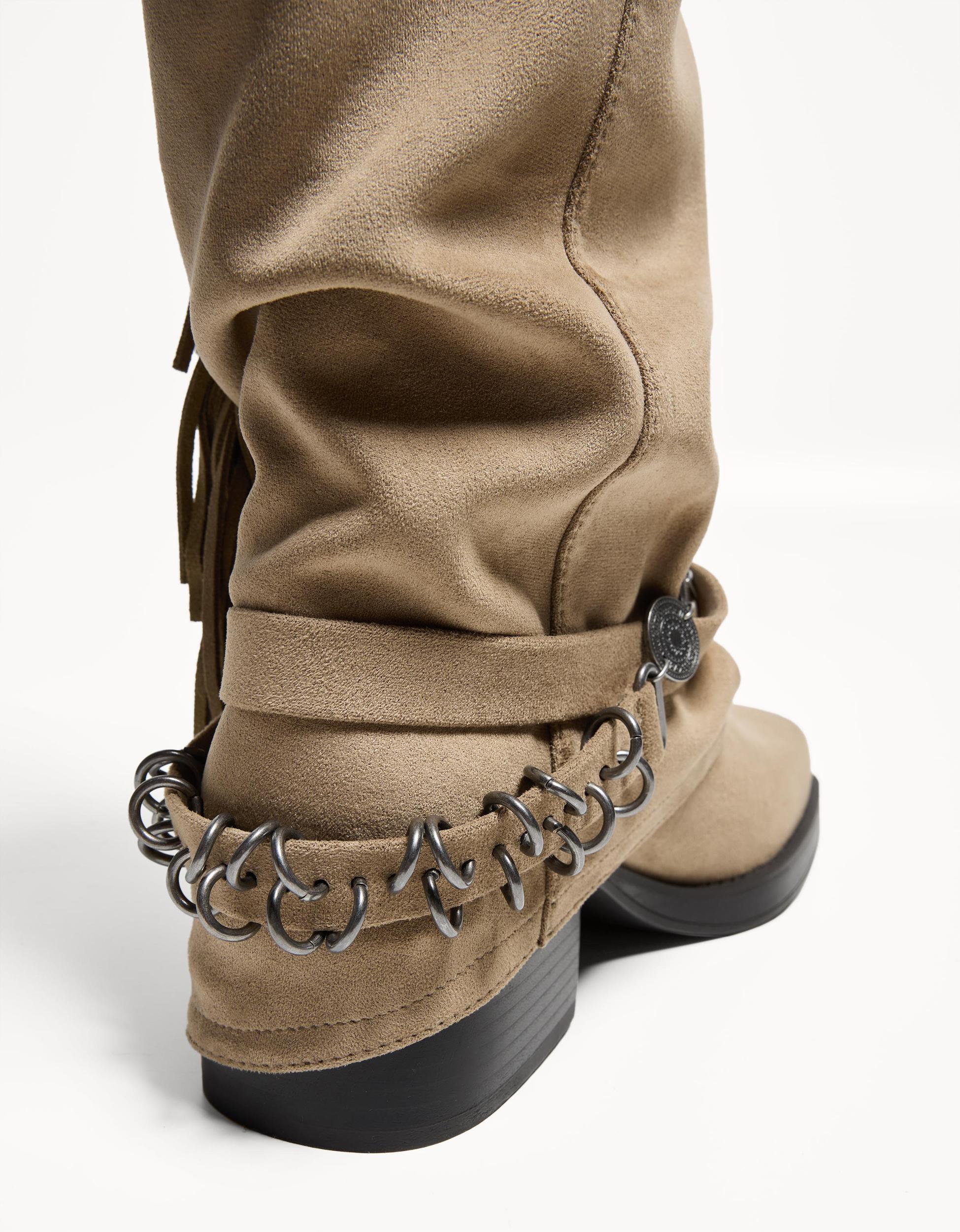 Flat boots with fringed pants Product Image