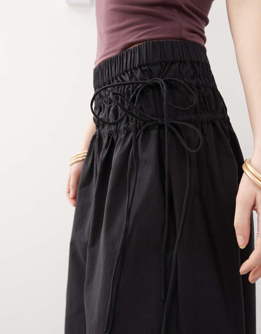 Reclaimed Vintage full poplin midi skirt with tie sides in black Product Image