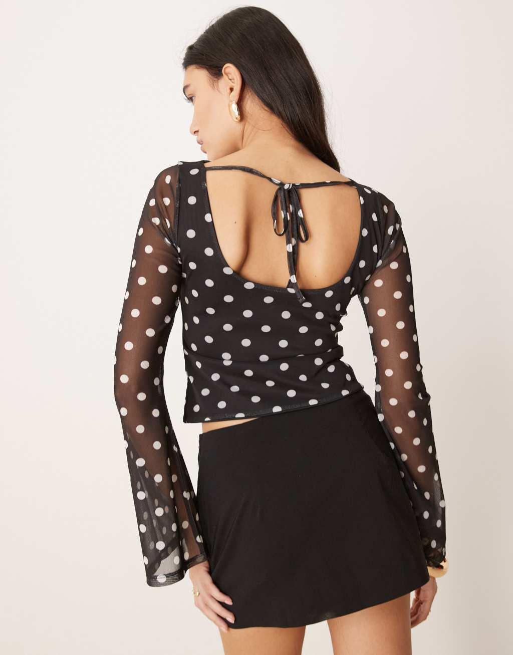 ASOS DESIGN polka dot printed mesh angel sleeve top with open tie back in black Product Image