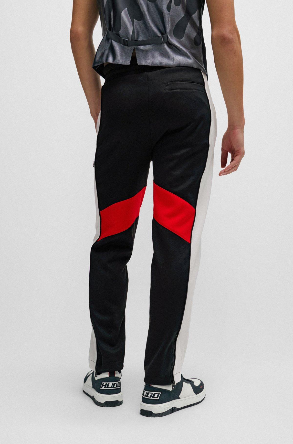 Relaxed-fit tracksuit bottoms with color-blocking Product Image