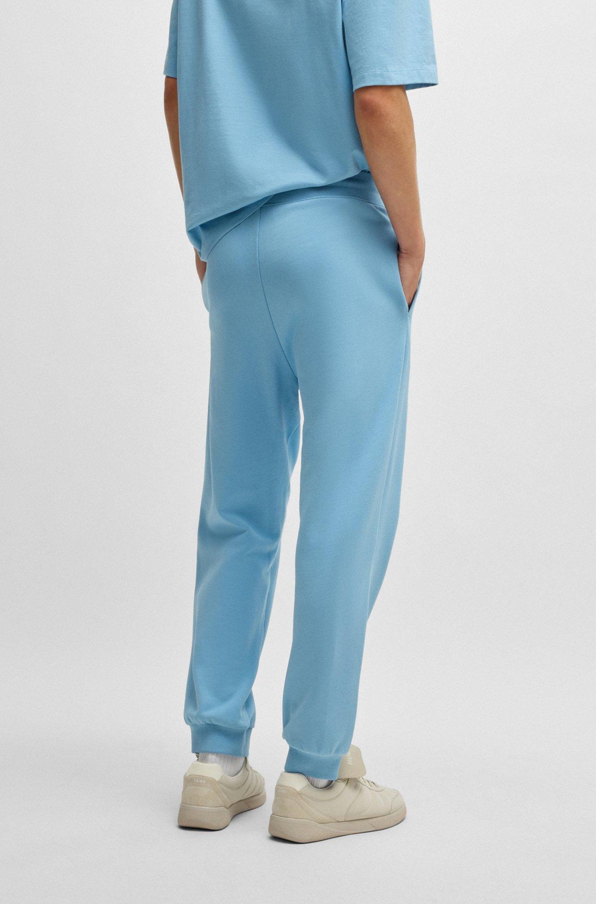 Cotton-terry tracksuit bottoms with Happy HUGO logo Product Image