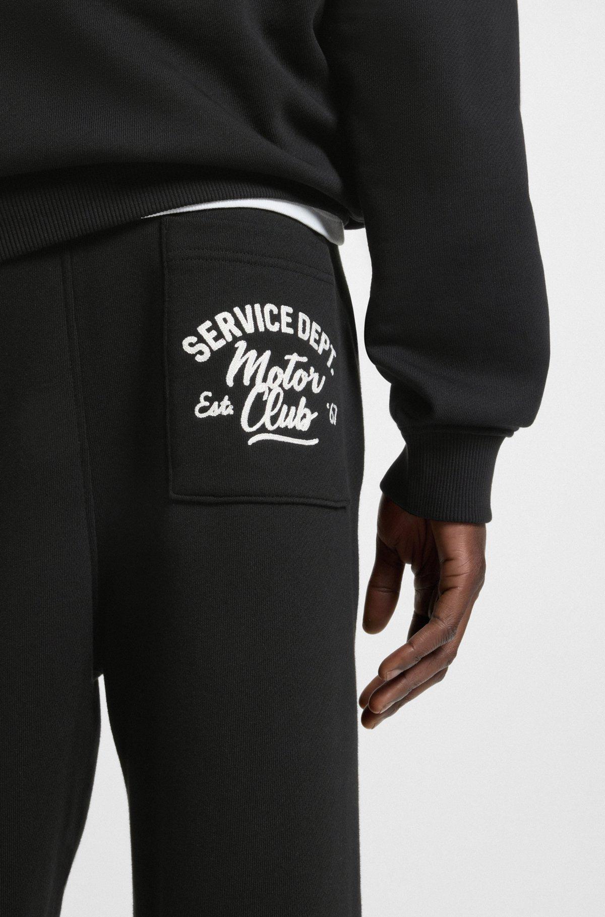 Cotton-terry tracksuit bottoms with embroidered graphics Product Image