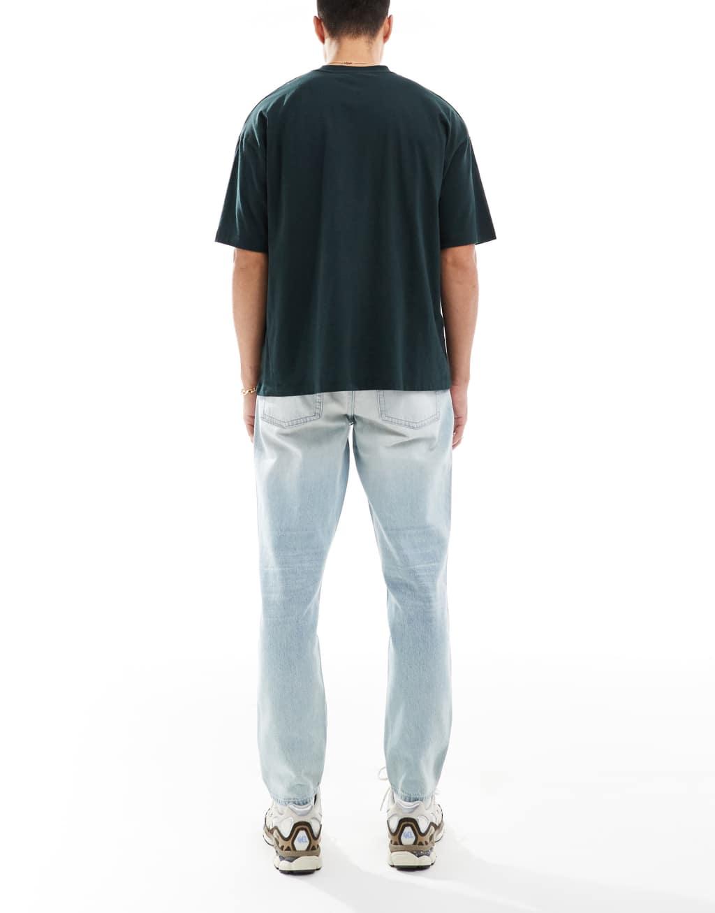 ASOS DESIGN tapered fit jeans in light wash blue Product Image