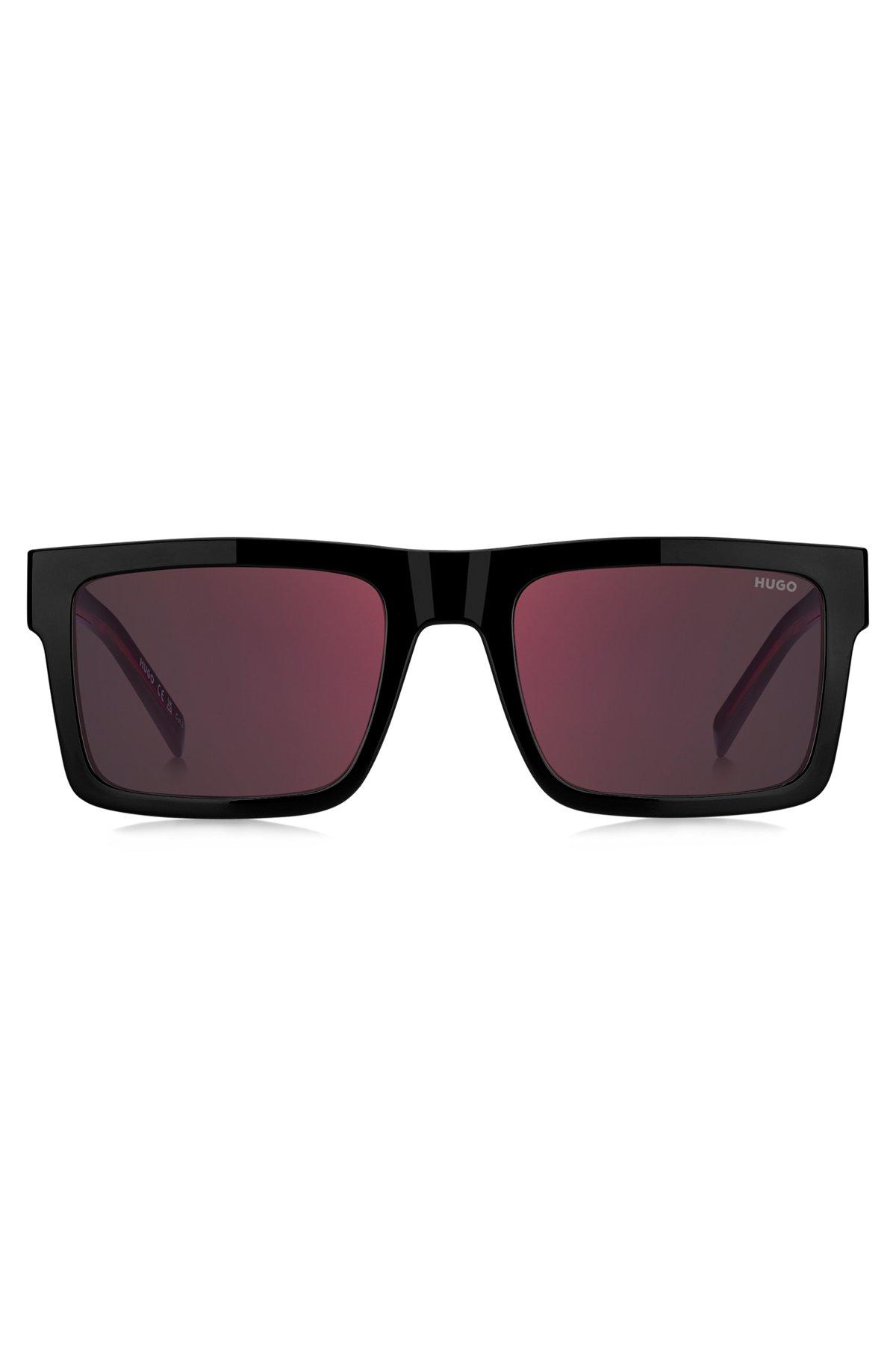 Black sunglasses with signature red accents Product Image