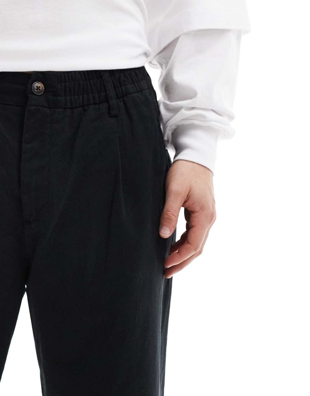 Jack & Jones loose fit pull-on chinos with pleated front in black Product Image
