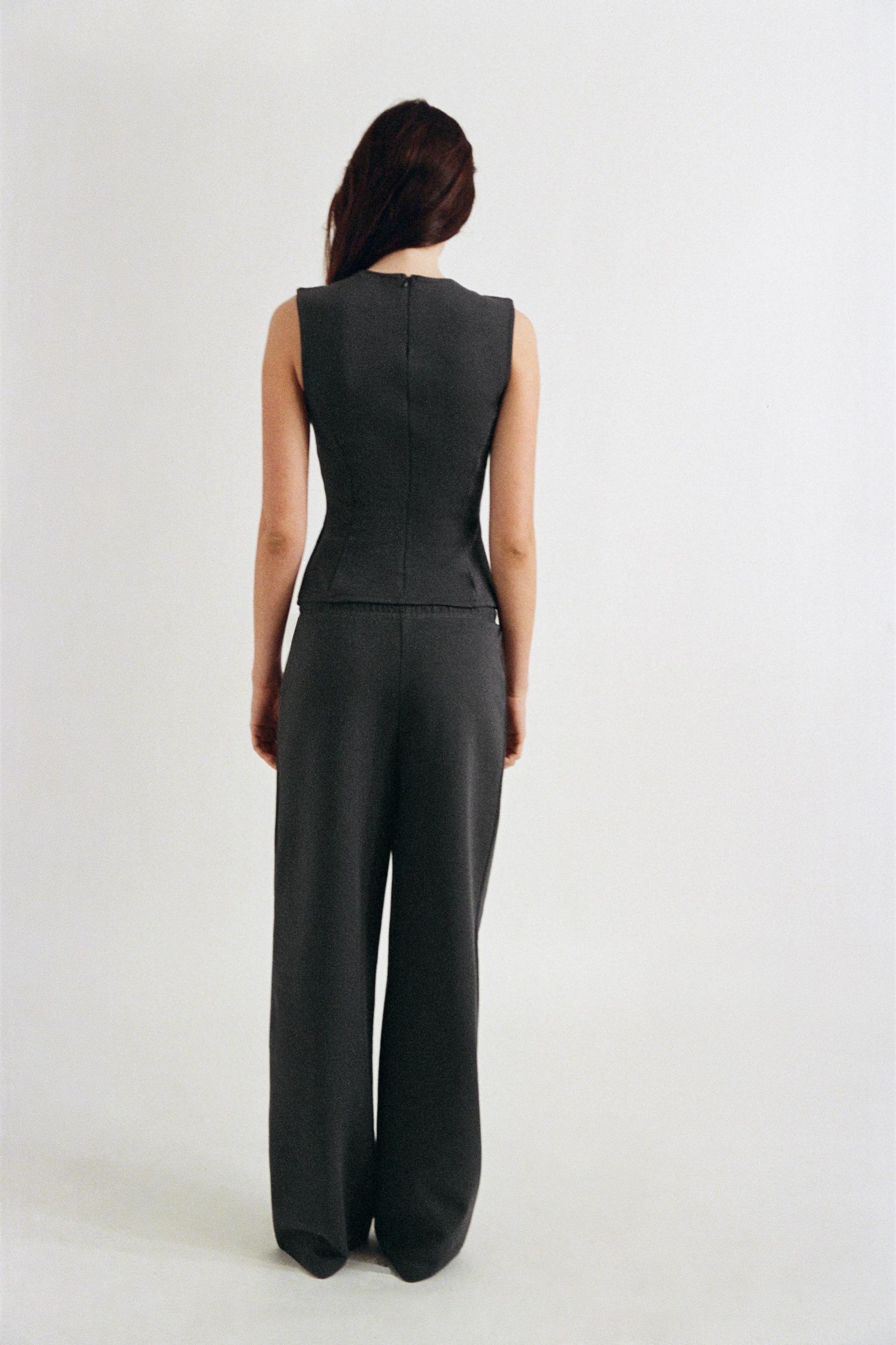 PEPLUM INTERLOCK TOP Product Image