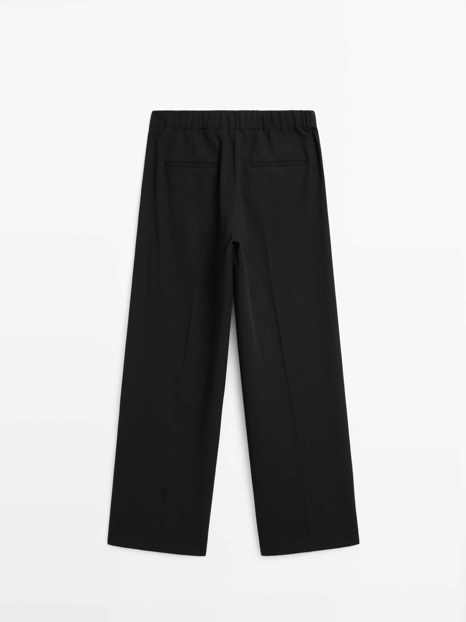 Wide-leg flowing trousers with darts Product Image