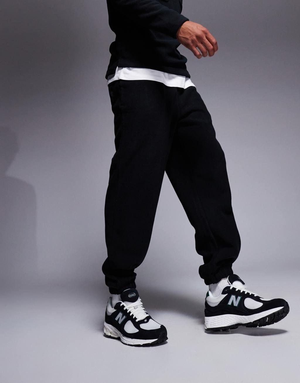 ASOS DESIGN tapered fleece sweatpants in black Product Image