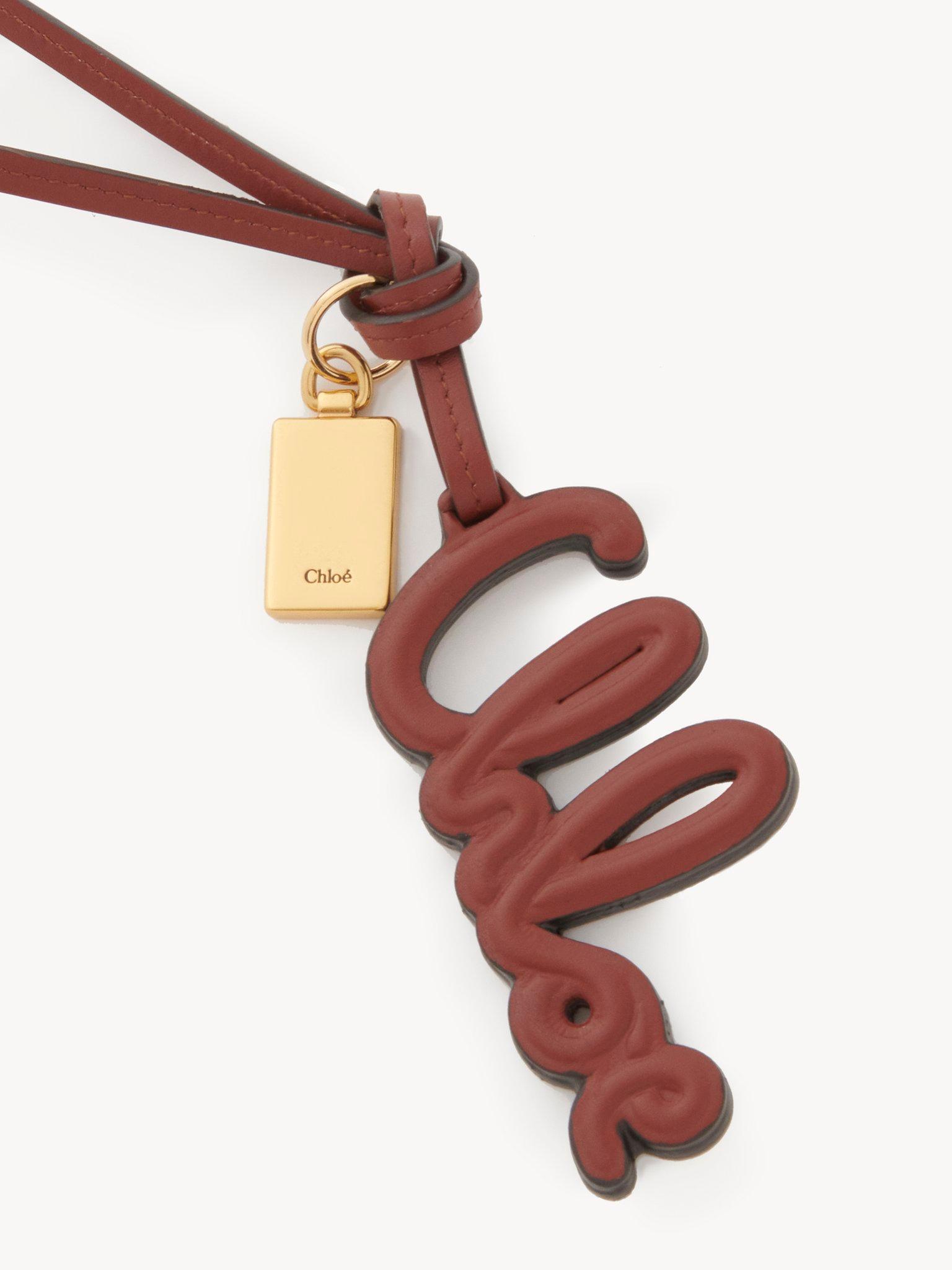 Logo bag charm in shiny leather Product Image