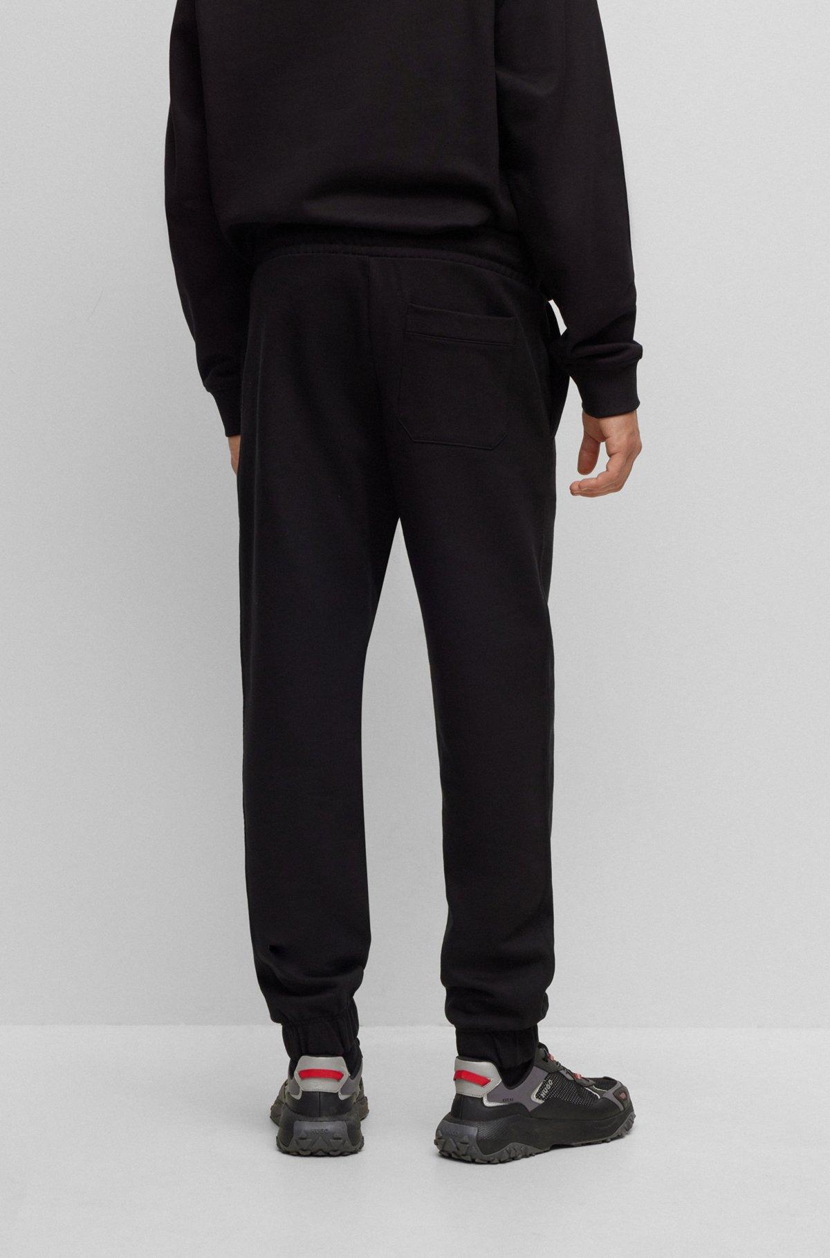 Relaxed-fit cotton-terry tracksuit bottoms with stacked logo Product Image