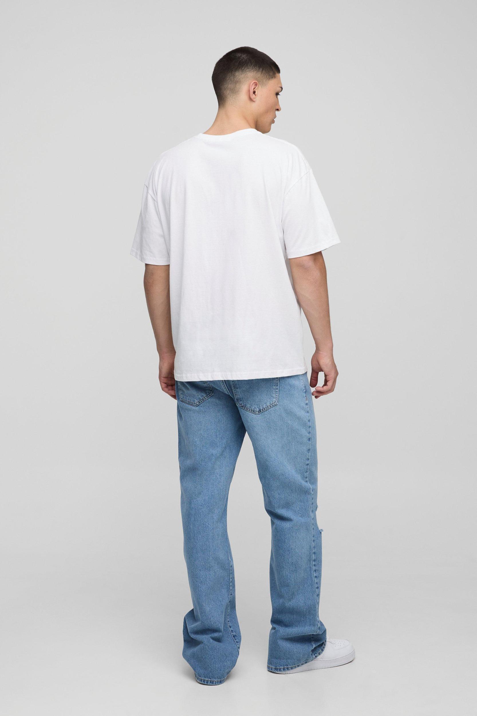 Relaxed Flared Ripped Knee Blue Wash Jeans | boohooMAN USA Product Image