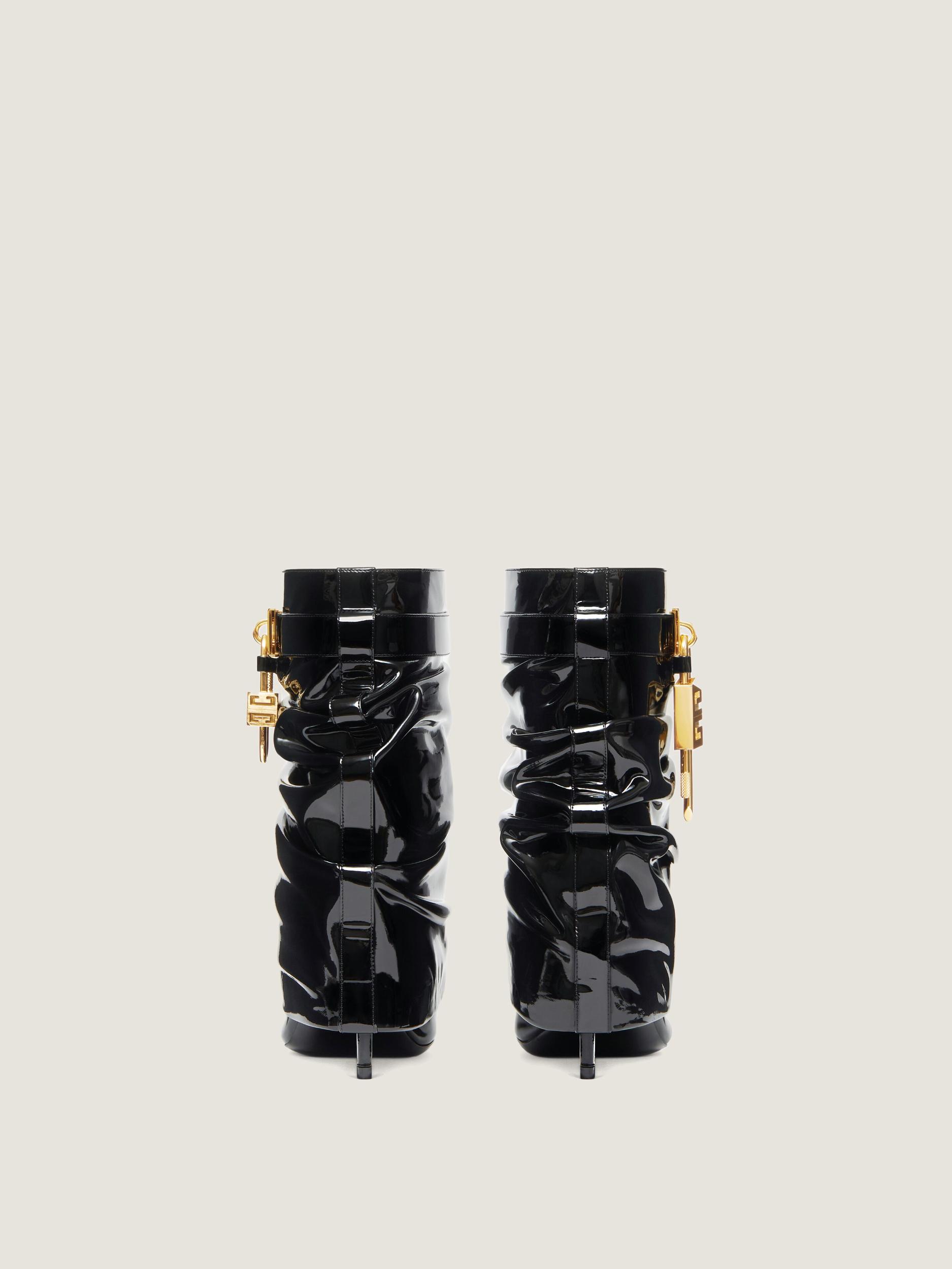 Shark Lock Stiletto ankle boots in latex Product Image