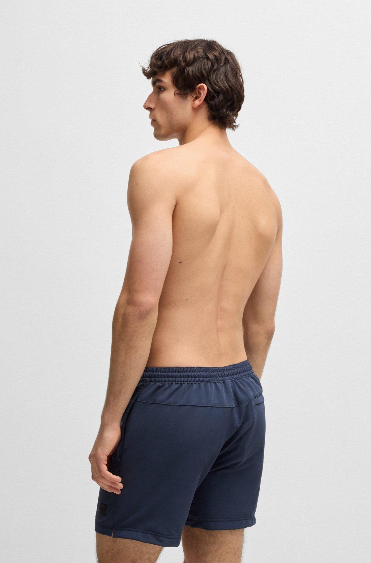 BOSS - Packable swim shorts with logo badge - Dark Blue Product Image