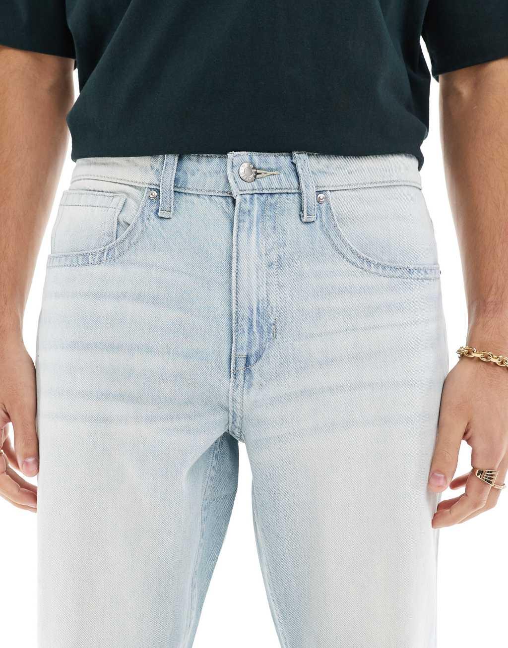 ASOS DESIGN tapered fit jeans in light wash blue Product Image