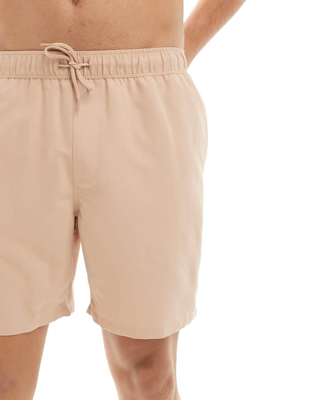 ASOS DESIGN swim shorts in mid length in beige Product Image