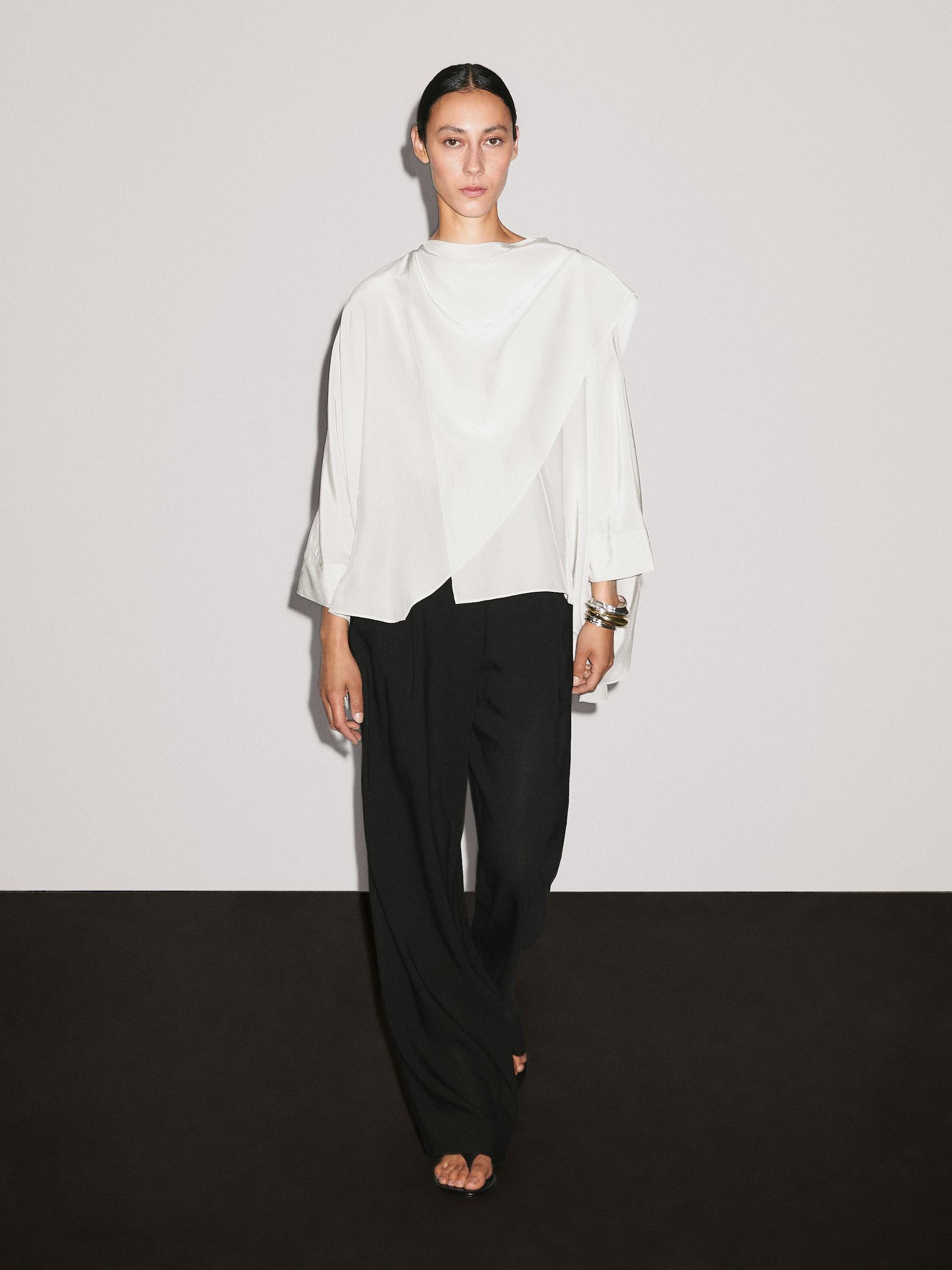 Short flowing cape with sleeve detail Product Image