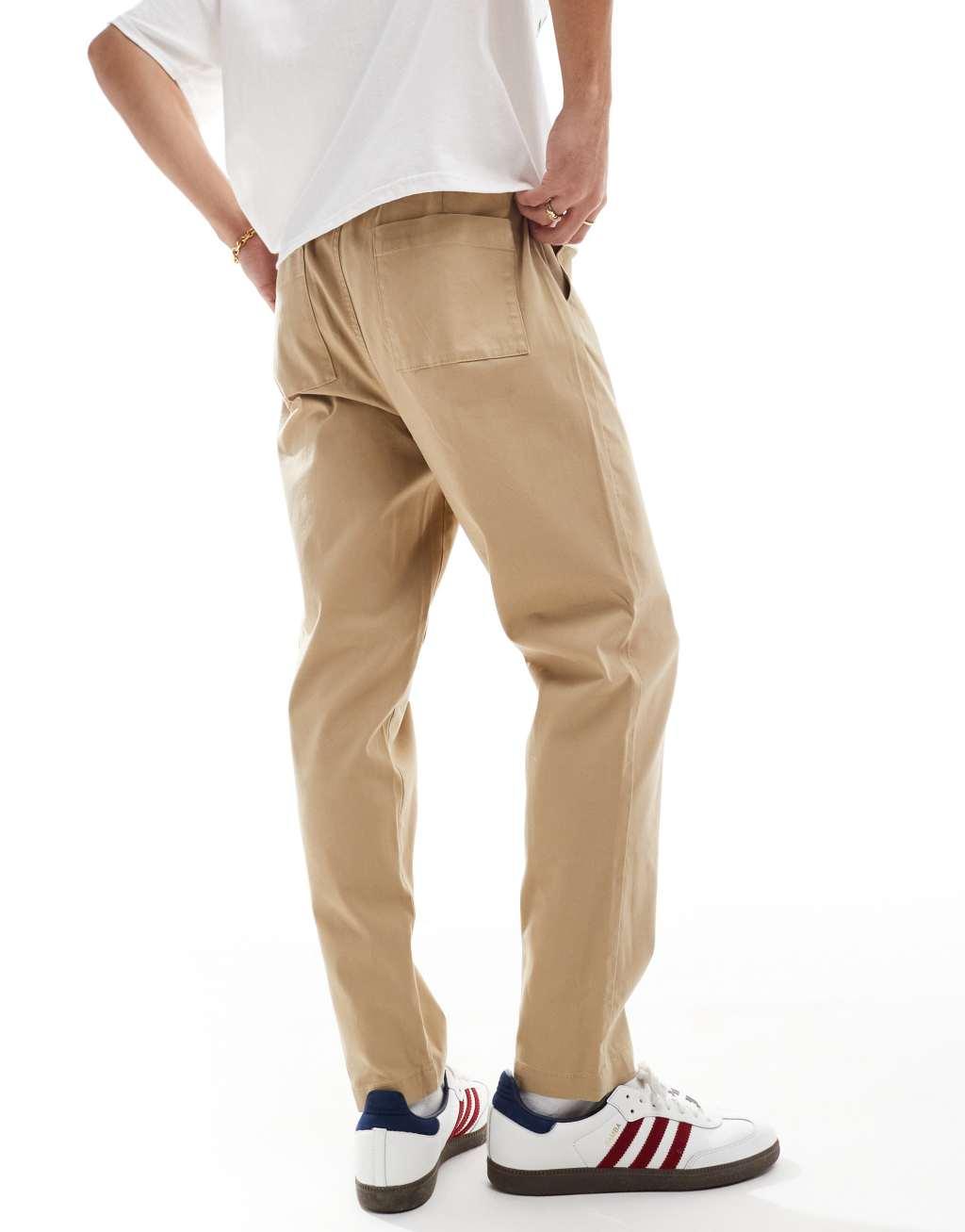 ASOS DESIGN tapered pull on chino with elastic waist in beige Product Image
