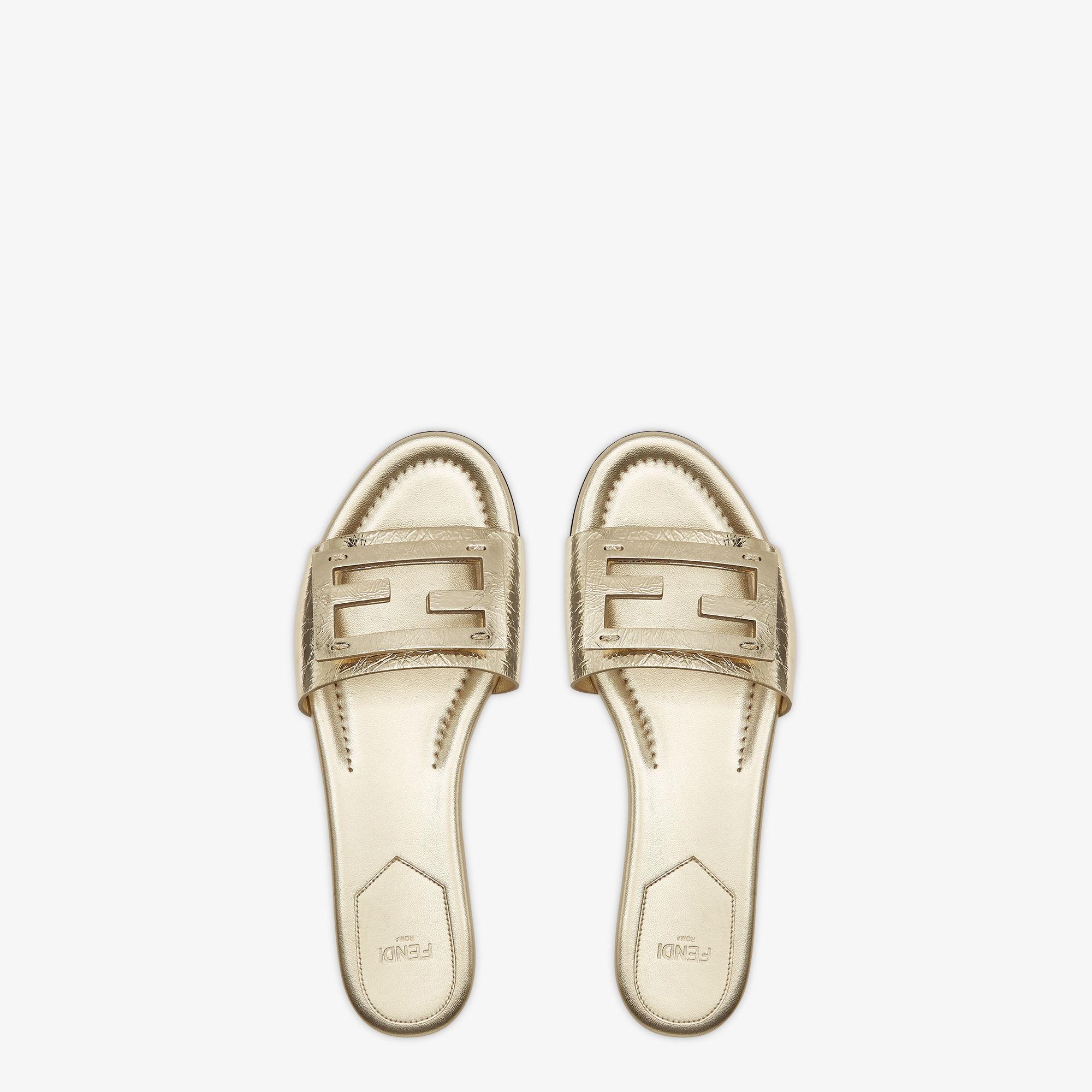 BaguetteMetallic champagne-colored leather slides Product Image
