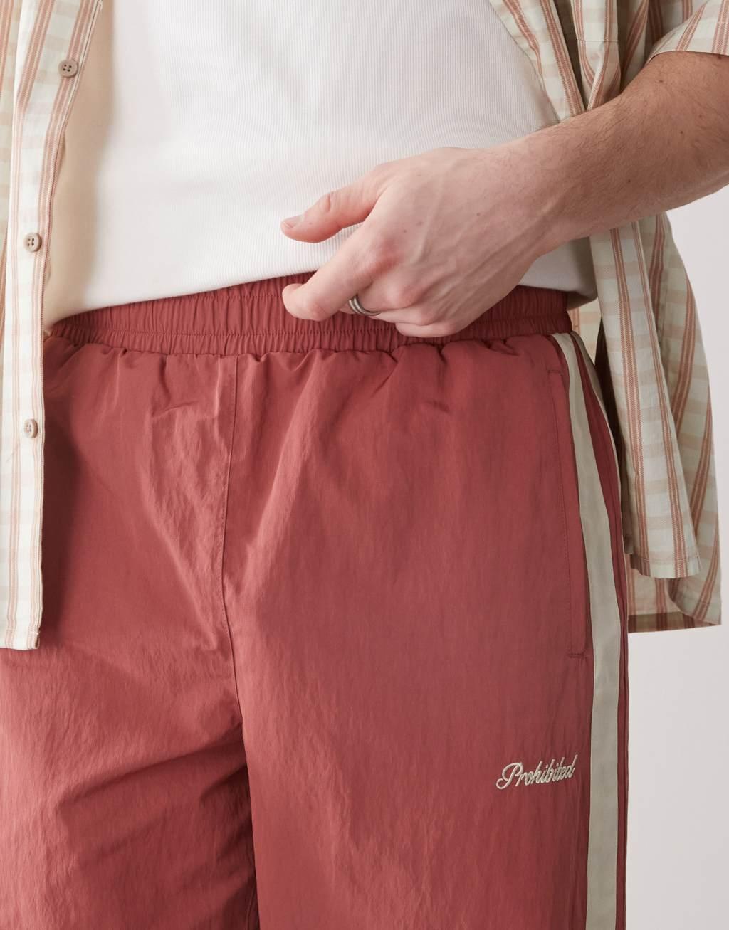 Prohibited stripe track pants in red Product Image