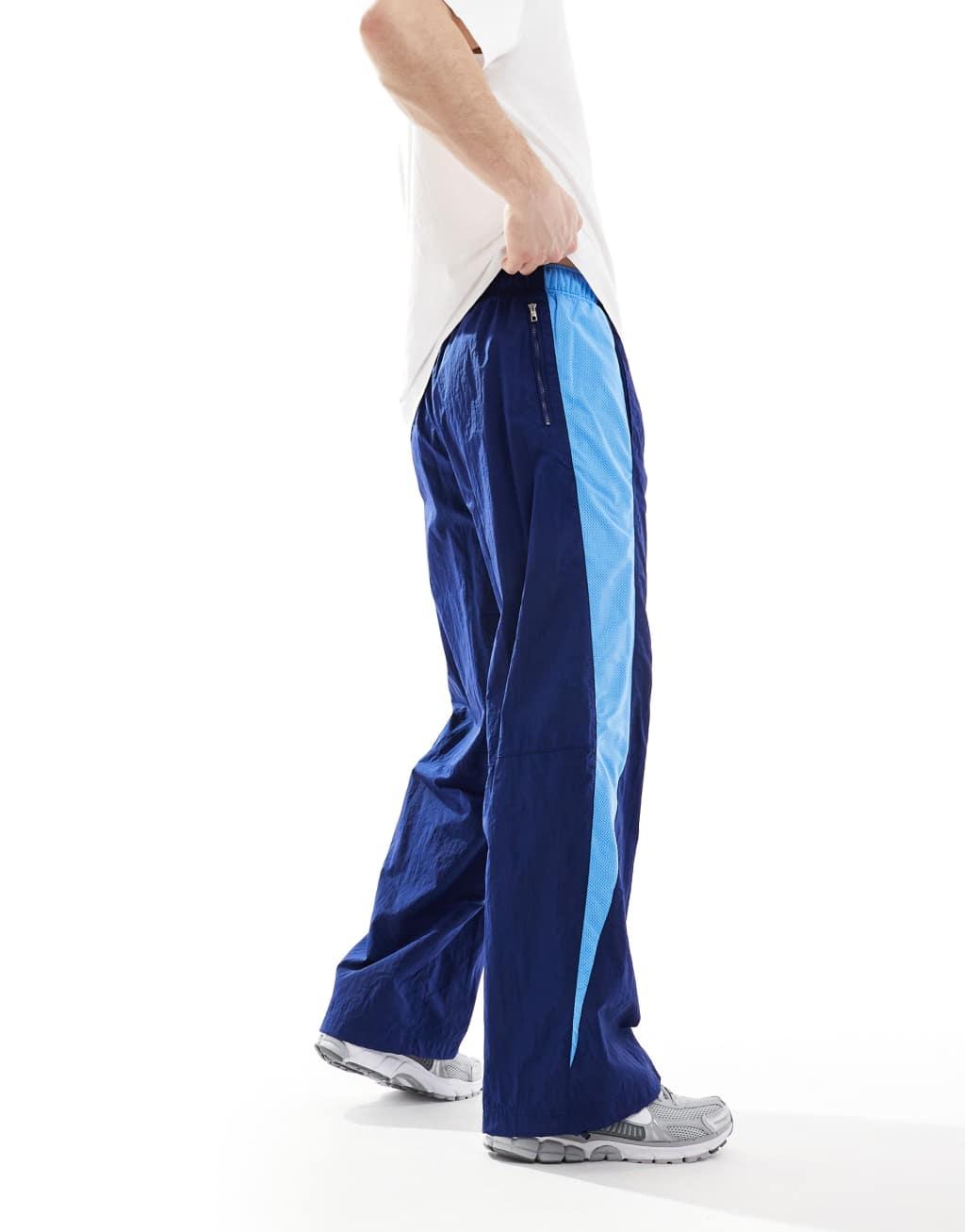 Nike Air woven paneled pants in navy and blue Product Image