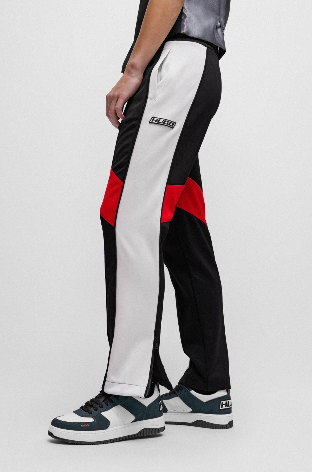 Relaxed-fit tracksuit bottoms with color-blocking Product Image