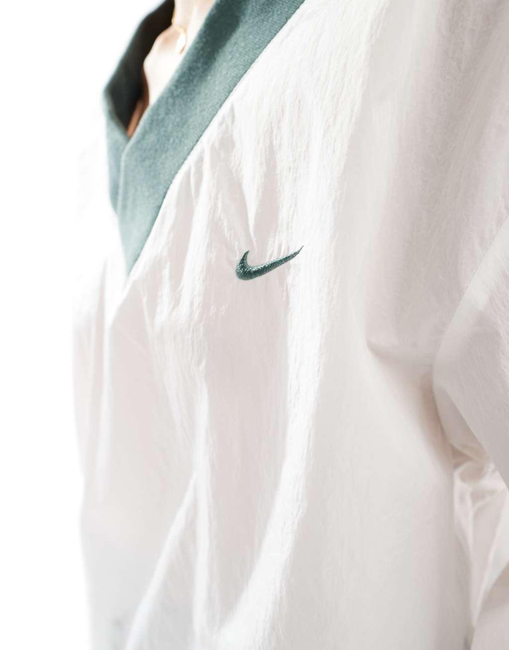 Nike Essential woven v-neck sweatshirt in off white and green Product Image