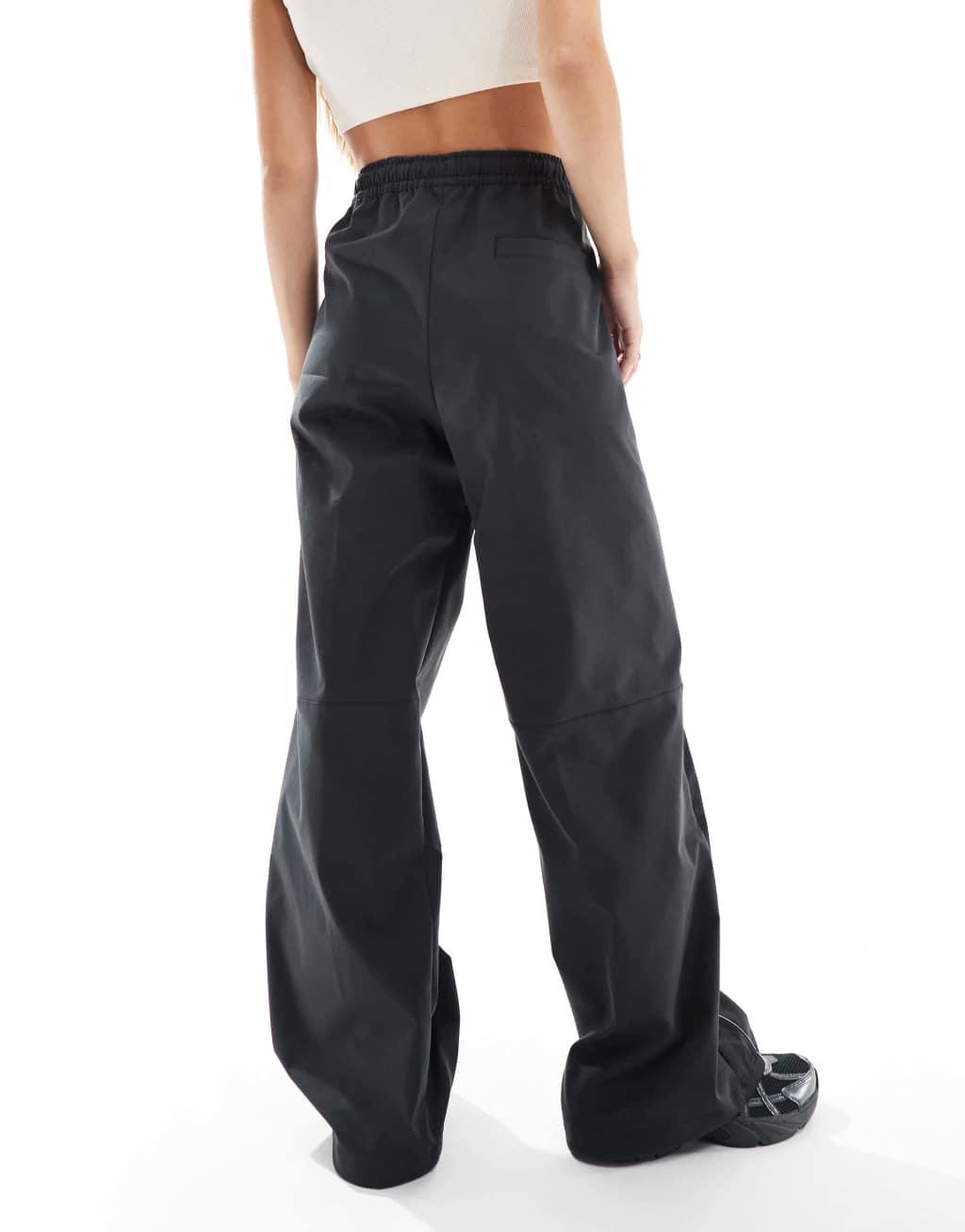 Nike paneled woven pants in black Product Image