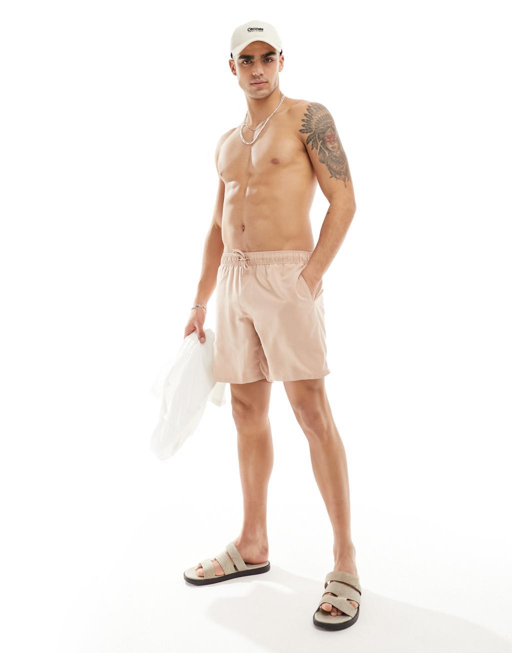 ASOS DESIGN swim shorts in mid length in beige Product Image