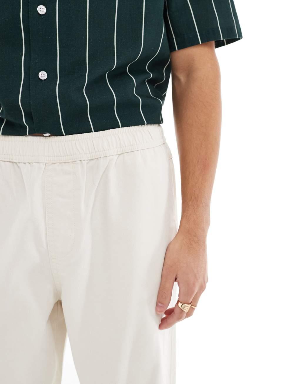 ASOS DESIGN baggy pull on pants with back pocket patch in ecru Product Image