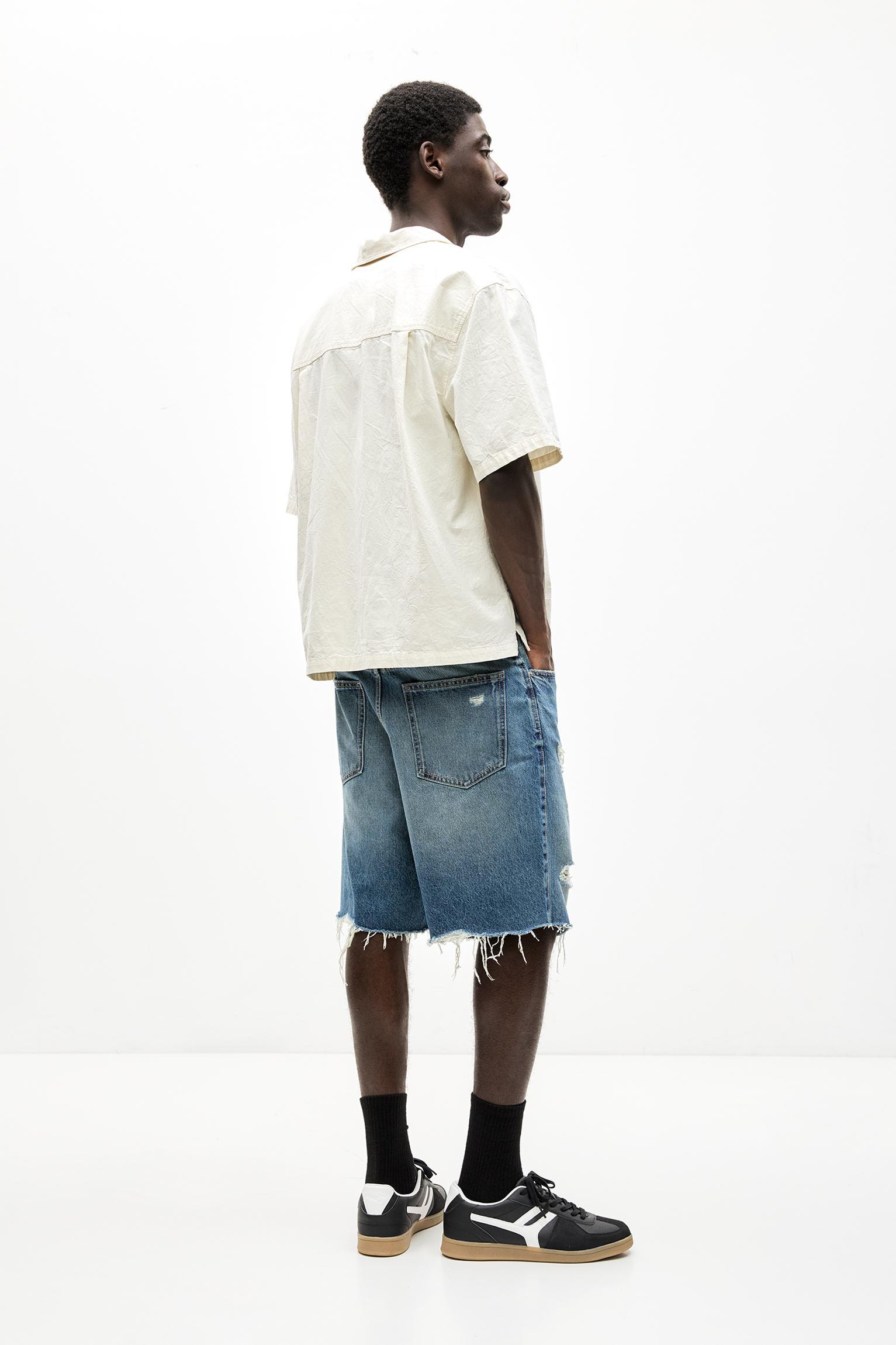 Ripped straight fit denim Bermuda shorts Product Image